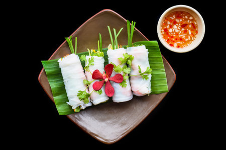 Vietnamese Pho spring roll with seafood, tofu, vegetables isolated on black background for a menu