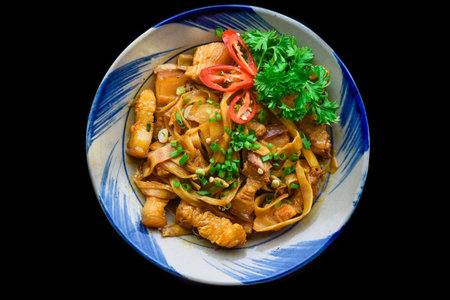 Vietnamese fried pork with noodle and ginger on black background