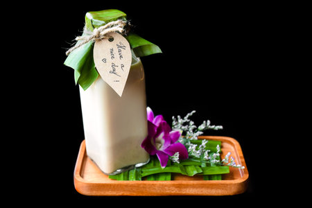 Yogurt with flowers and sign Have a nice day isolated on black backgroundの写真素材