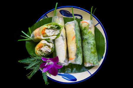 Vietnamese nem spring rolls in leaf with sauceの写真素材