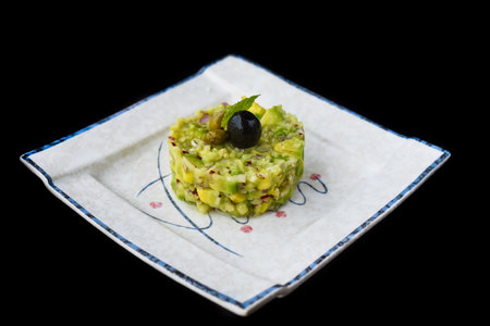 Vegetarian zucchini and avocado tartare with oliveの写真素材