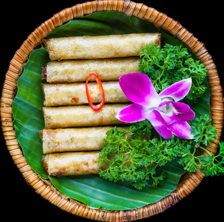 Traditional fried vietnamese spring rolls with pork, rice paper on black background side view