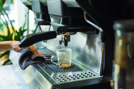 coffee machine making espresso in a cup close upの写真素材