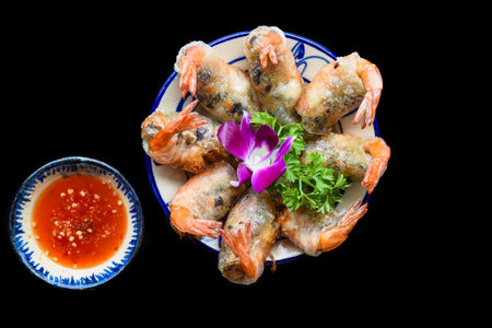 Traditional fried vietnamese spring rolls with shrimps and pork, rice paper on black backgroundの写真素材