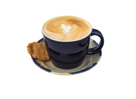 Cappuccino with heart on foam on plate with homemade cookie isolated on white backgroundの写真素材