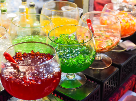 Different fruit jelly in glass bowls for tea and ice cream in vietnamese night marketの写真素材