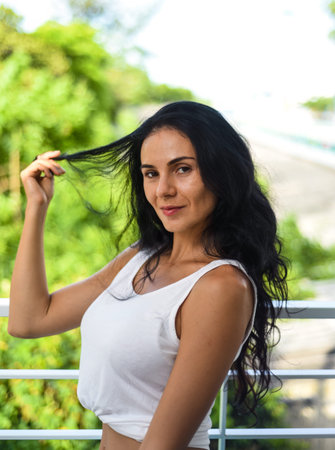 Portrait of sexy ukrainian woman touching her hair and looking at camera