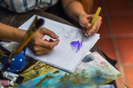 Woman artist and illustrator drawing sketches by pencilの写真素材