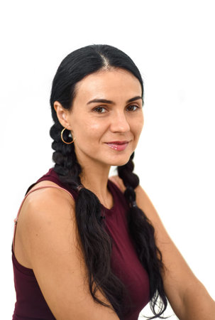 Portrait of ukrainian woman with braids looking at camera against white backgroundの写真素材