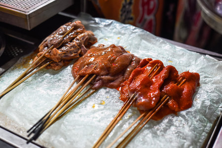 Marinated raw meat on the sticks prepared for bbq in the Jalan Alor street food in Kuala Lumpur, Malaysiaの写真素材