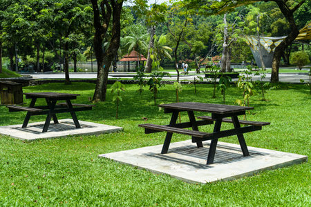 Wooden furnuture with table and bench in the Kuala Lumpur central park without people