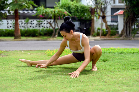 Ukrainian woman making stretching for yoga practicing outdoorsの写真素材