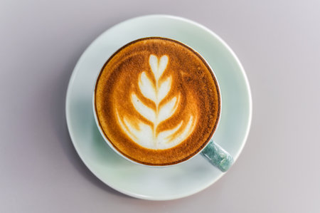 Cup of cappuccino with drawing on light gray background top viewの写真素材