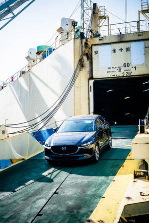Vladivostok, Russia - 3 March 2024: unloading of new car from the ship in sea port of Vladivostok,...