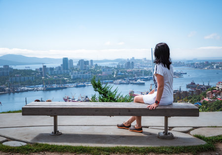 Russian 50 years old woman looking at Vladivostok landscape view of Zolotoy bay, view from Nagorny park, Primorsky regionの写真素材
