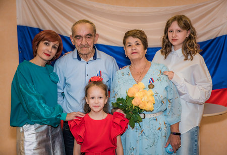 A Russian family celebrates their golden wedding anniversary at the registry office. The elderly...