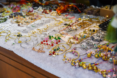 Colorful beaded bracelets with stones and charms for sale at a market in Shanghai, China. Handmade jewelry for small business and retail.の写真素材