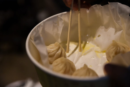 Close-up of steamed Chinese dumplings with crab and pork in a take-out bowl on Yuyuan Old Street,...