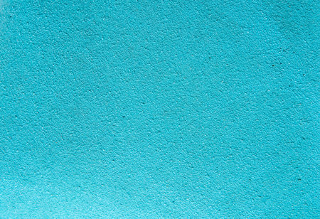 Bright turquoise textured surface, perfect for use as a background in design projects, presentations, templates, posters, or digital graphics with copy space.の写真素材