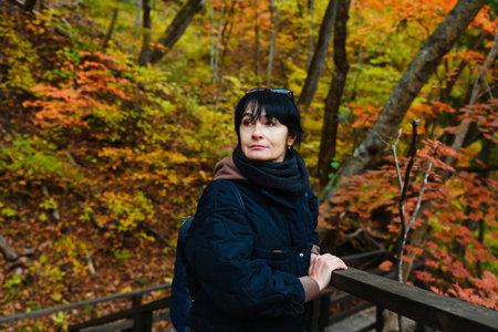Russian woman 50 years old solo traveler half length portrait on forest stairs Far East Russia...