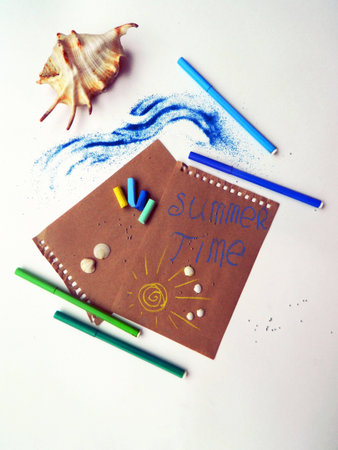 Blank sheets of craft paper covered with multiple colorful felt pen markers, shellsの写真素材