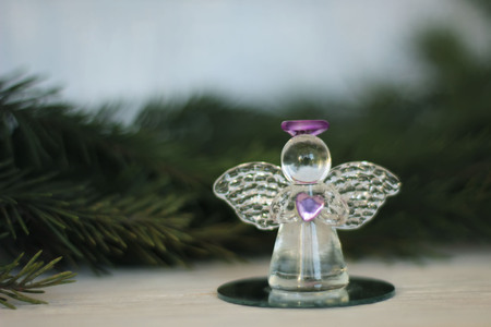 Glass angel decoration and Christmas tree branch as background, place for textの写真素材