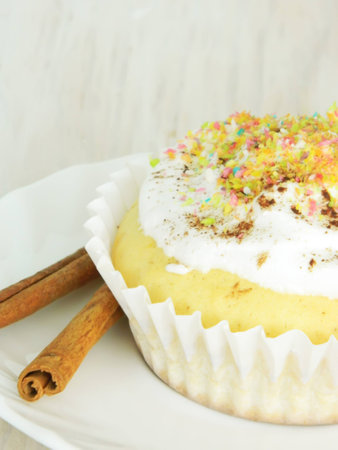 Sweet homemade condensed milk cupcake and cinnamon sticksの写真素材