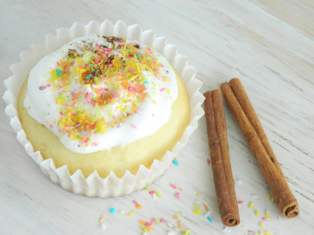 Sweet homemade condensed milk cupcakes and cinnamon sticksの写真素材