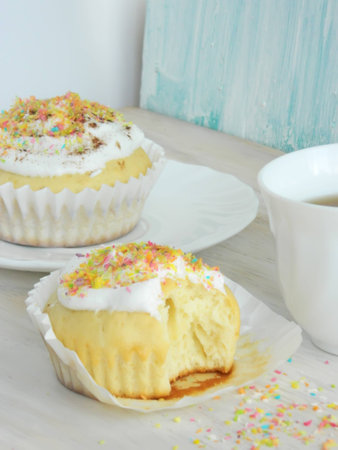 Sweet homemade condensed milk cupcakes with whipped cream and coconut shavingsの写真素材