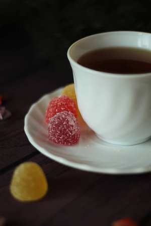 Berry-fruit marmalades, tea on a dark wooden background and christmas treeの写真素材