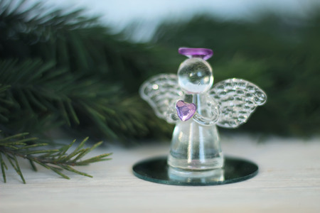 Glass angel decoration and Christmas tree branch as backgroundの写真素材