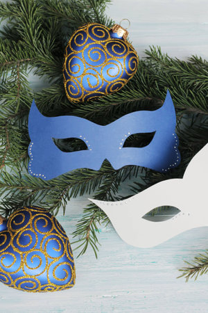 Carnival masks - green and white - on christmas tree branchの写真素材