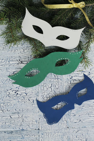 Carnival mask sand christmas tree on wooden background with cracksの写真素材