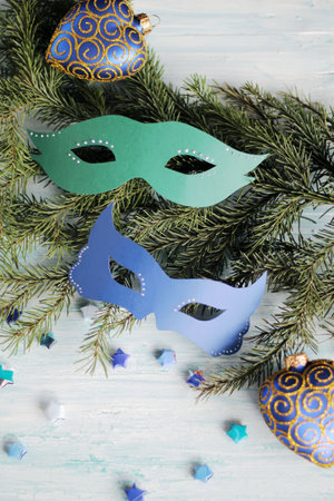 carnival masks on christmas tree branch with baublesの写真素材