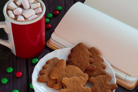 Christmas homemade gingerbread cookies, hot chocolate with marshmallows, red and green candies and...