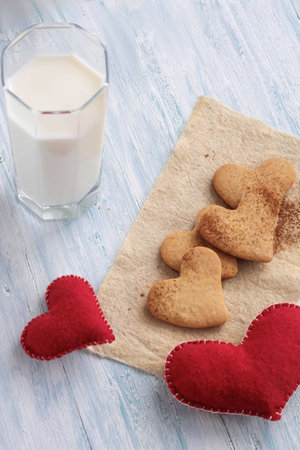 Tasty cookies and glass of milk on shabby wooden background top viewの写真素材