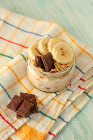 banana and muesli in a jar, scene on a rustic wood backgroundの写真素材