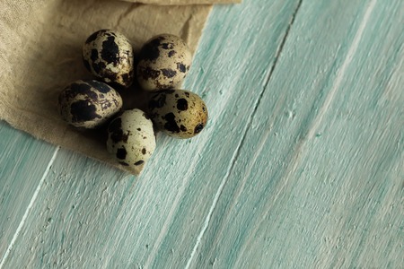 Easter composition of five quail Easter eggs on turquoise wooden background easter background top view place for textの写真素材
