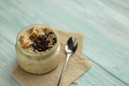 Breakfast smoothie jar topped with chocolate, muesli and sesame seeds. healthy vegan food conceptの写真素材