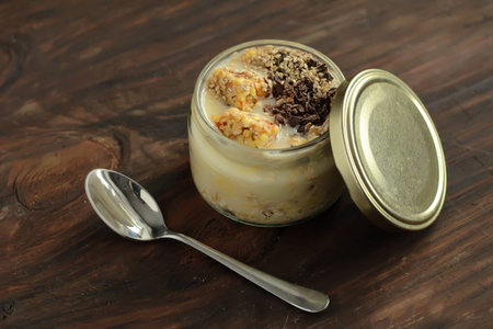 breakfast muesli and chocolate smoothie jar topped with sesame seeds and energy barsの写真素材