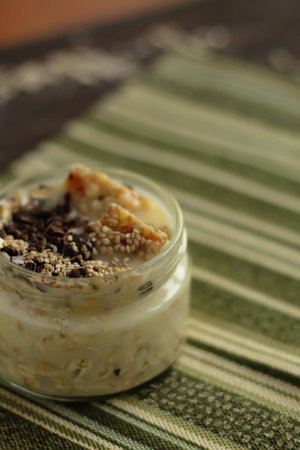 breakfast muesli and chocolate smoothie jar topped with sesame seeds and energy barsの写真素材