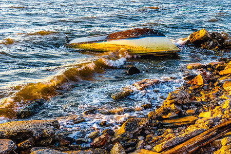 Shipwreck after an winter storm overturned fishing boatの写真素材