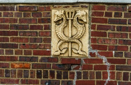 Bas-relief two seahorses on a old red brick wallの写真素材