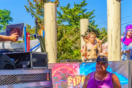 People walking in the 39th Annual Provincetown Carnival Gods and Goddess Parade on Commercial Street...