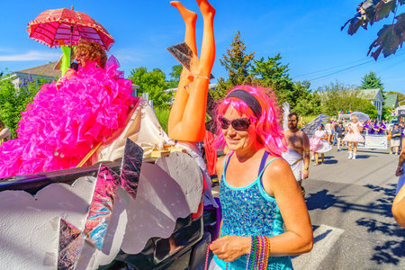 People walking in the 39th Annual Provincetown Carnival Gods and Goddess Parade on Commercial Street...