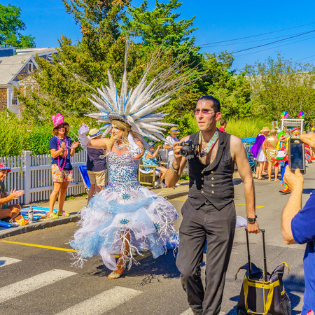 People walking in the 39th Annual Provincetown Carnival Gods and Goddess Parade on Commercial Street in Provincetown, Massachusetts August 17, 2017 USAのeditorial素材