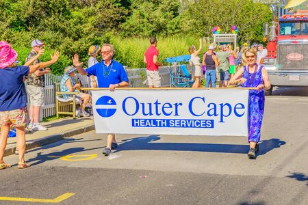 People walking in the 39th Annual Provincetown Carnival Gods and Goddess Parade on Commercial Street in Provincetown, Massachusetts August 17, 2017 USAのeditorial素材