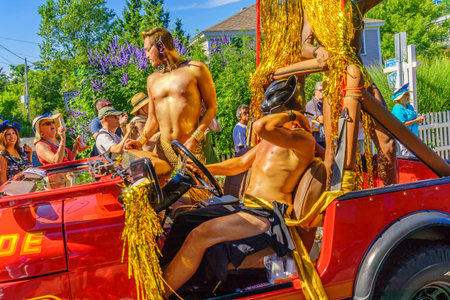 People walking in the 39th Annual Provincetown Carnival Gods and Goddess Parade on Commercial Street...