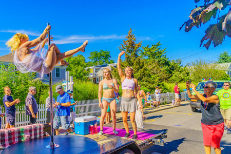 People walking in the 39th Annual Provincetown Carnival Gods and Goddess Parade on Commercial Street...