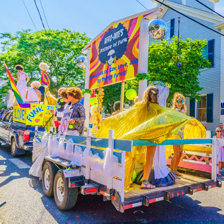 People walking in the 39th Annual Provincetown Carnival Gods and Goddess Parade on Commercial Street...